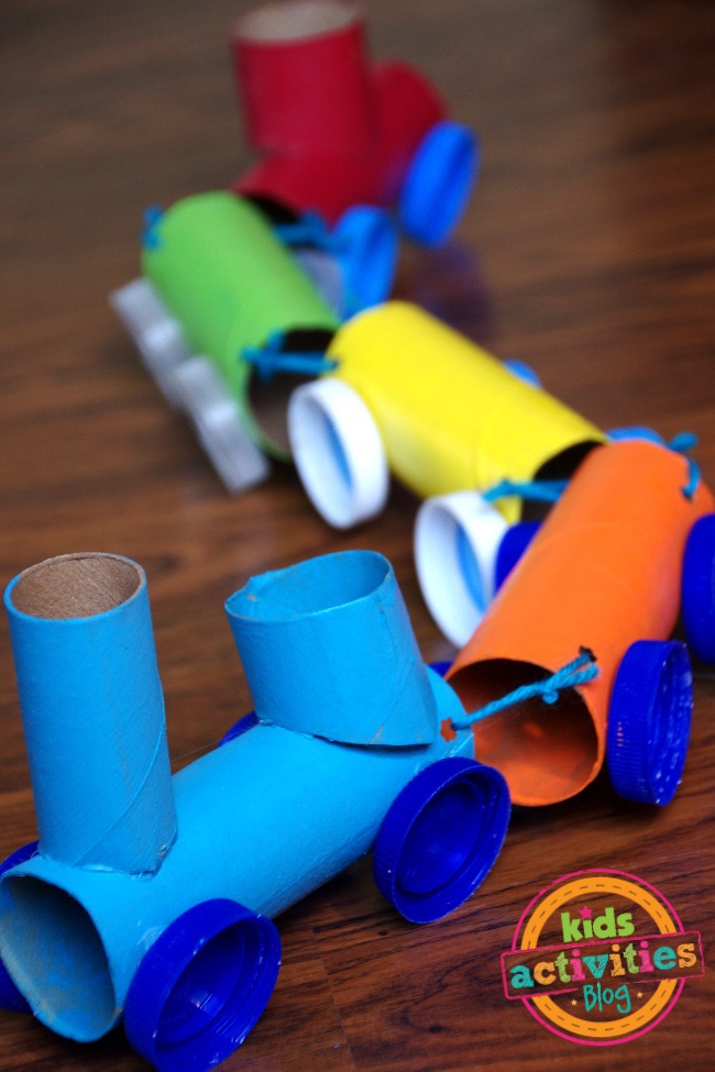 Toilet Paper Roll Train Craft for kids - shown is the finished toilet paper roll train with an engine and 3 cars and a caboose