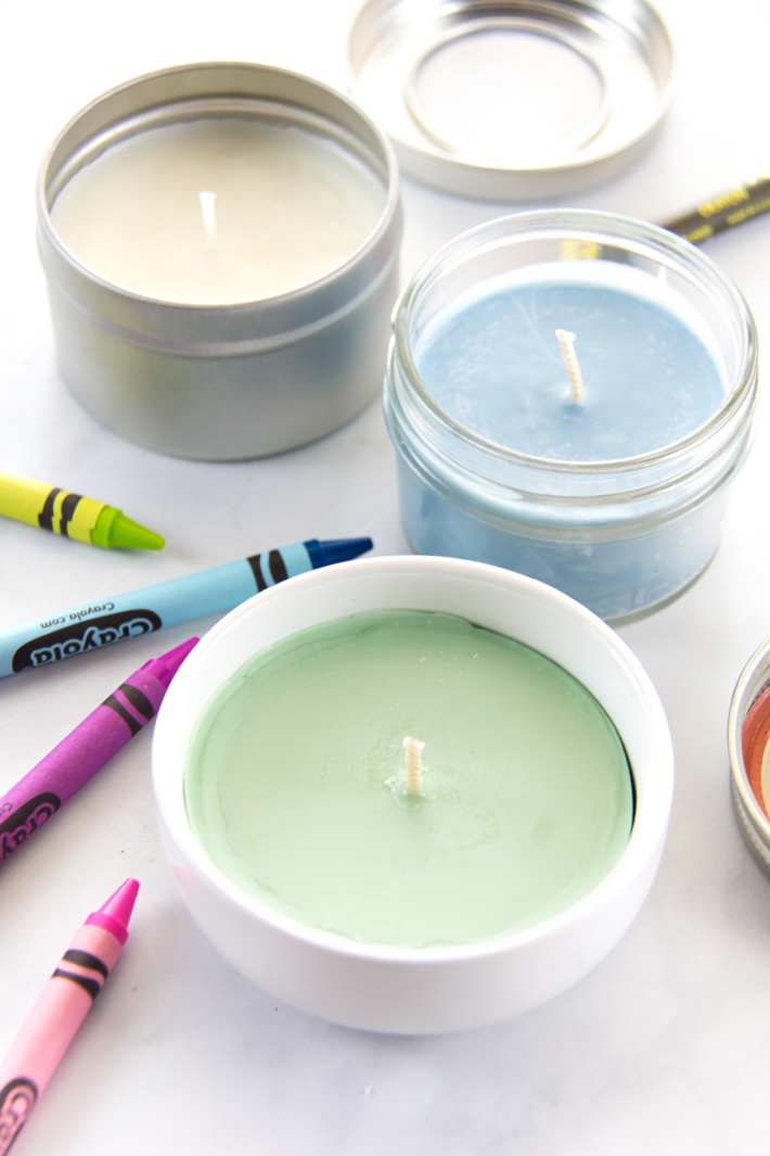 Homemade crayon candles in dishes, jars, and containers