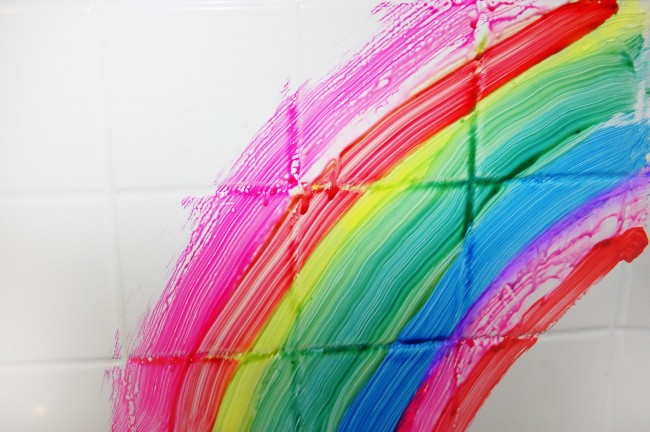 bathtub tile shown painted with homemade bath paint in the colors of a rainbow
