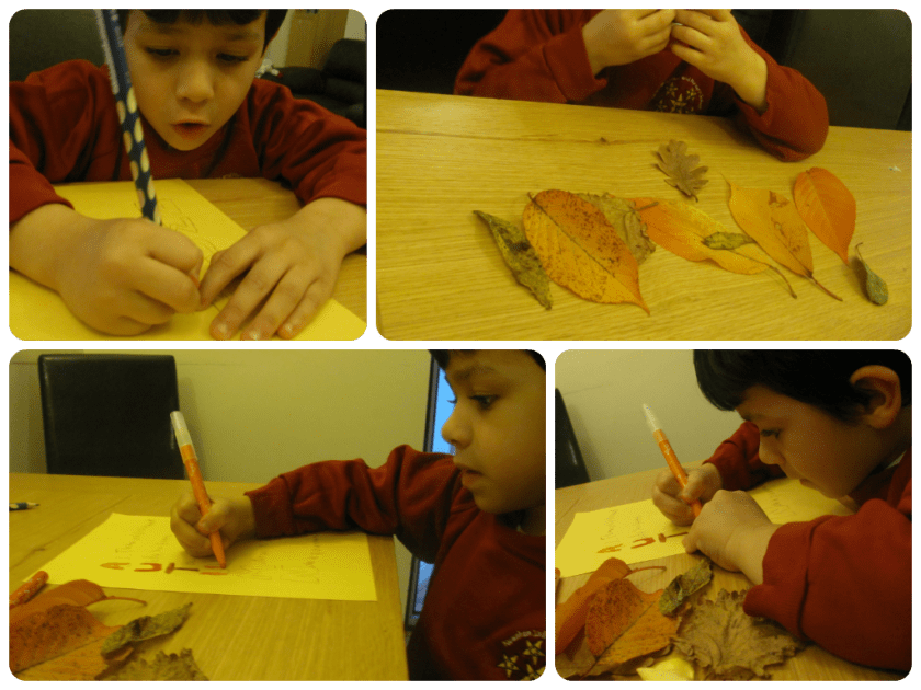 Child writing a poem on paper with crayons and adding leaves to the paper.