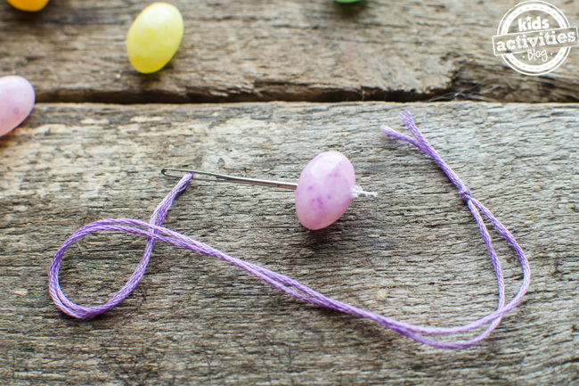 Easter jelly bean activity threading jelly beans onto purple thread
