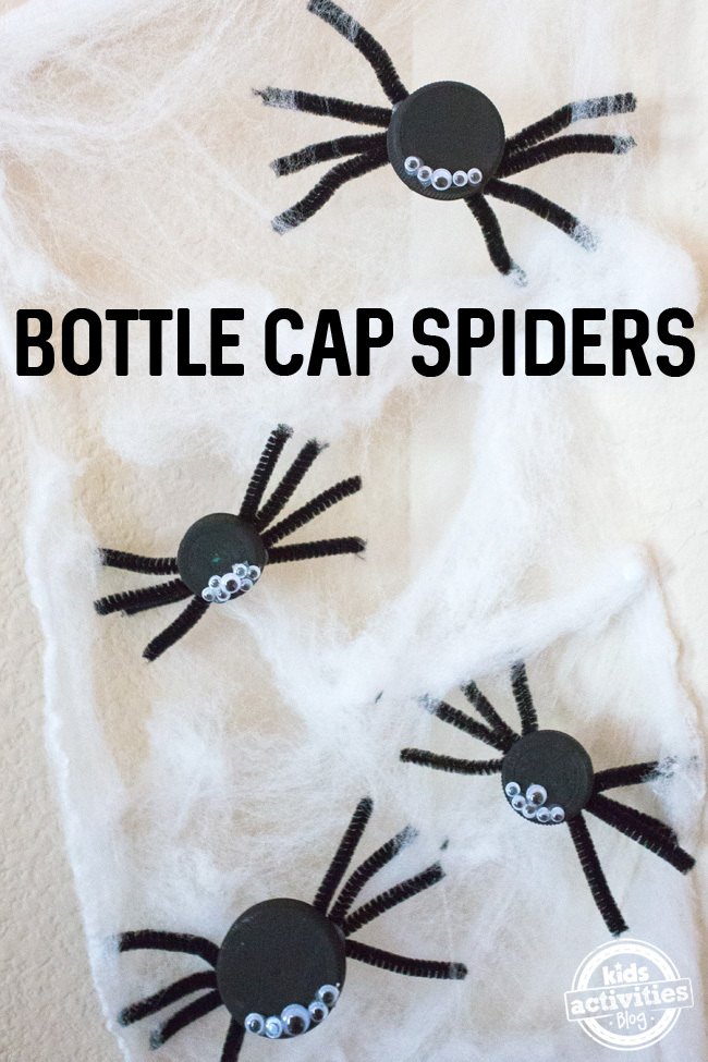 Halloween Bottle Cap Spiders craft for kids - 4 spiders made out of bottle caps shown in some spider web material