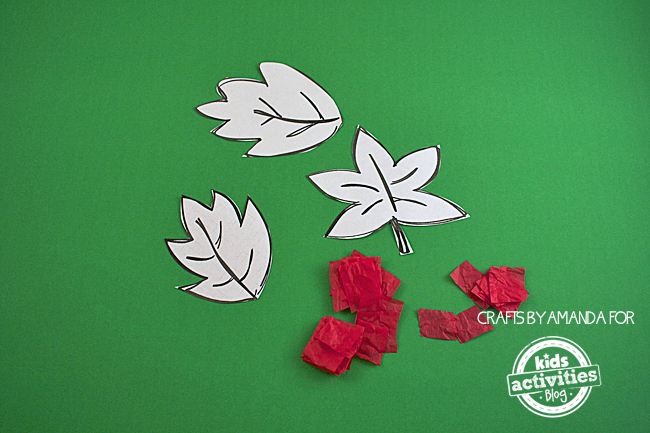Fall Craft: Tissue Paper Leaves - first step showing cut out leaf shapes from leaf template and red tissue paper squares