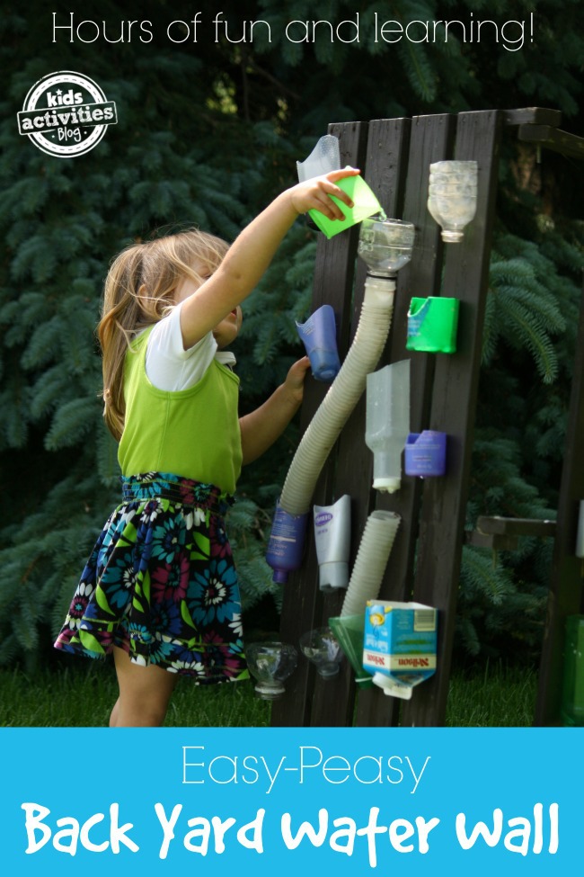 Build a backyard water wall for hours of fun and learning - Kids Activities Blog - child pouring water into a container at the top of the homemade water wall