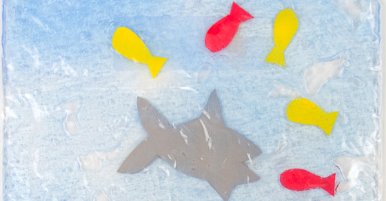 Feed The Shark Sensory Bag with yellow and red fishes and a gray shark in blue "water"