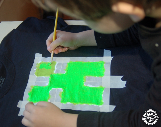 Minecraft Creeper T-Shirt Tutorial- painting squares green around the masking tape