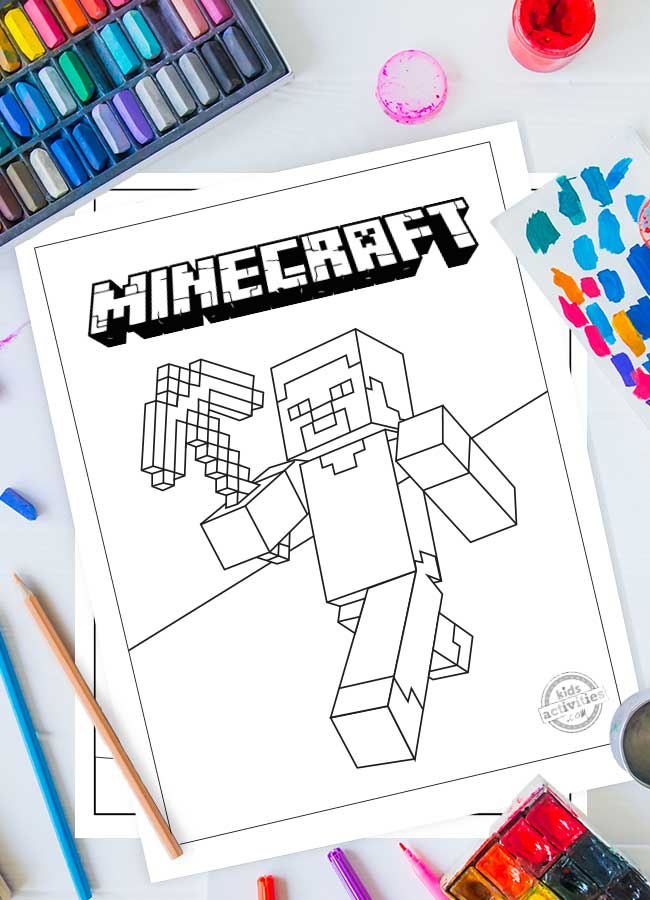 A Minecraft coloring sheet printed on white paper with Steve holding a diamond axe. Art supplies surround the printable. 