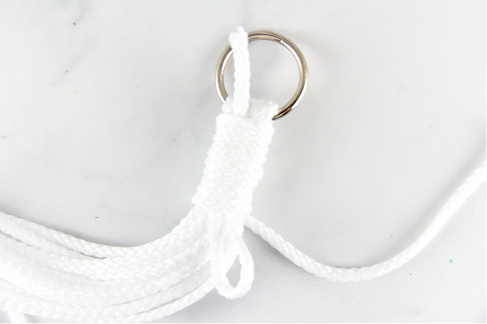 How to secure a knot under a ring for a macrame plant hanger.