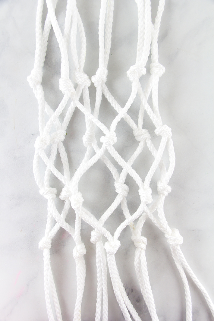 A macrame net that will go over a potted plant.