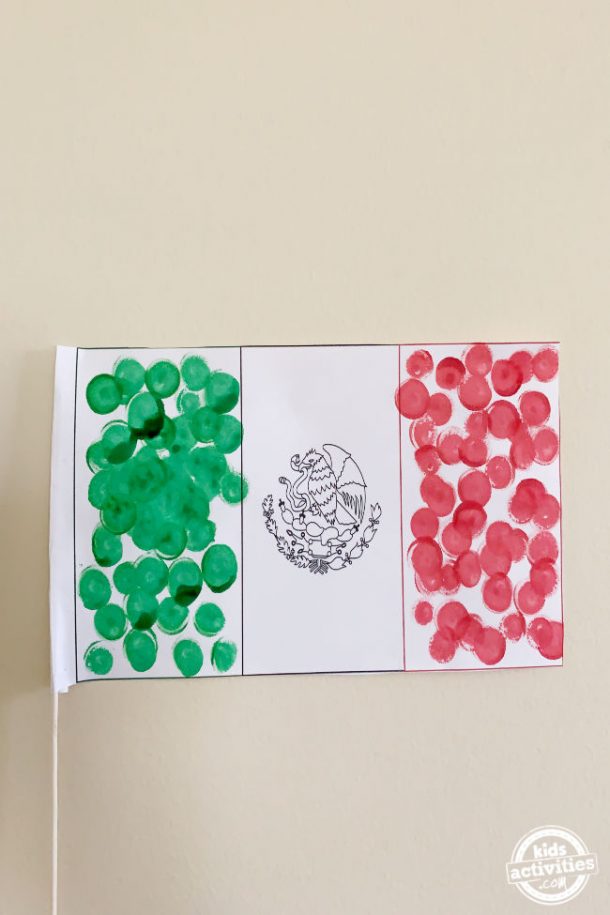 Mexican flag made by preschool kids using dot markers with pole shown