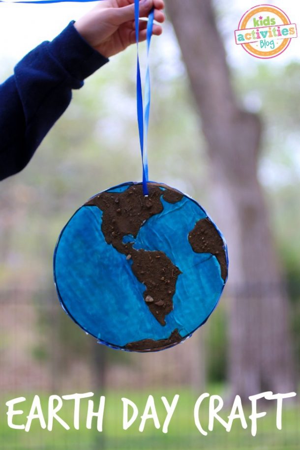 Earth Day Craft for Kids made of recycled berry boxes, paint, and dirt to look like the world.