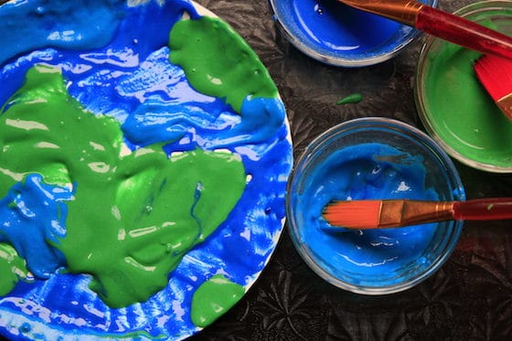 Puffy paint Earth Day art project from Happy Hooligans - paper plate shown with green and blue paint