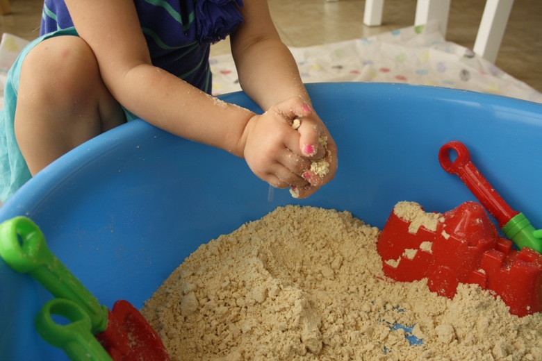 Indoor beach sensory bin from Mama Papa Bubba using sand and other sand play items