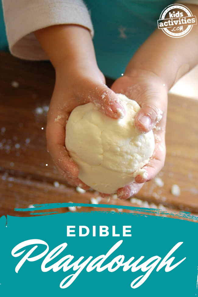 yummy edible playdough made from cool whip and cornstarch - shown is child's hands playing with edible play dough on a kitchen counter