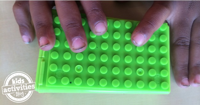 press the plate onto your gum case for a pocket lego play game
