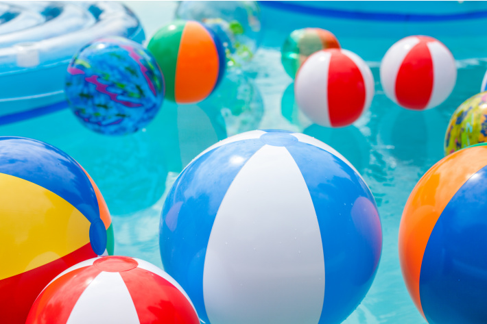 Beach balls in the pool ready for playing sight word game - Kids Activities Blog