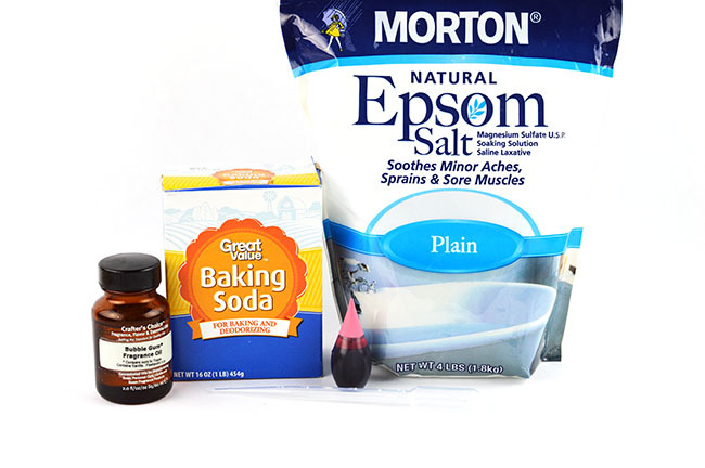 epsom salt bath for kids ingredients including bubble gum fragrance, baking soda, food coloring, and epsom salt.