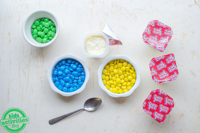 yellow and blue make green snack idea - showing first step of color mixing snack experiment for kids
