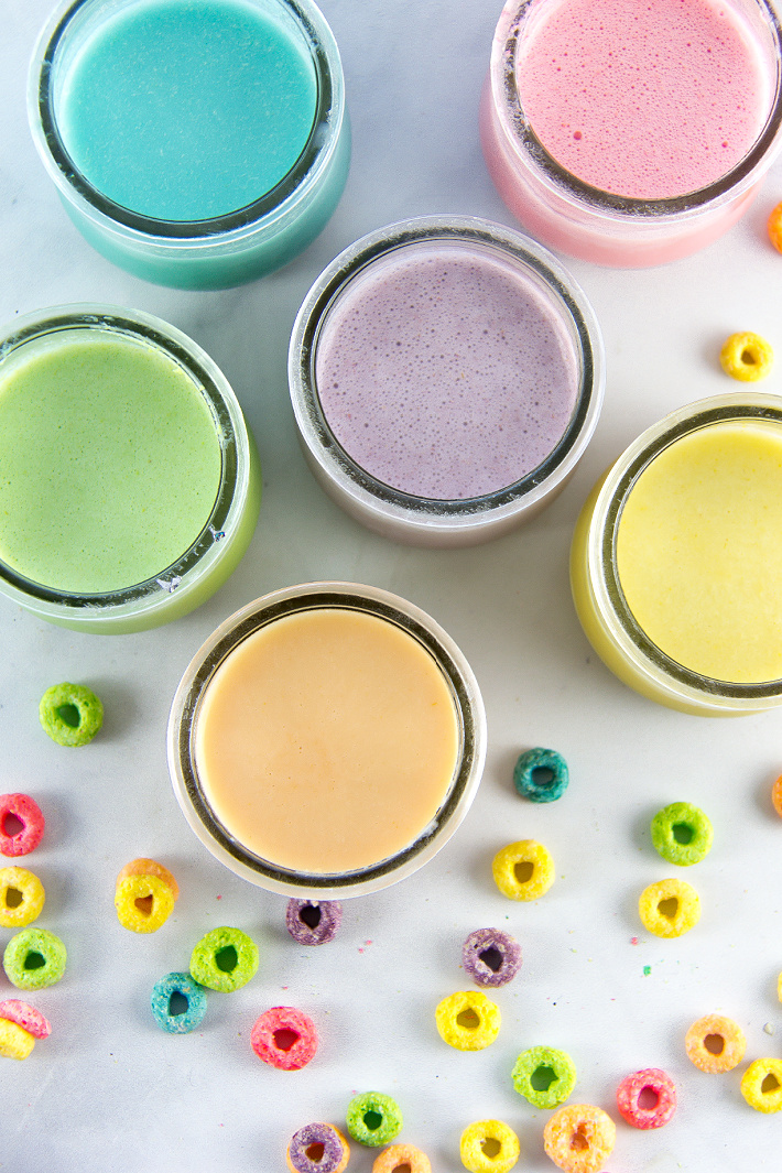 small yogurt jars filled with homemade paint made out of Fruit Loops and yogurt