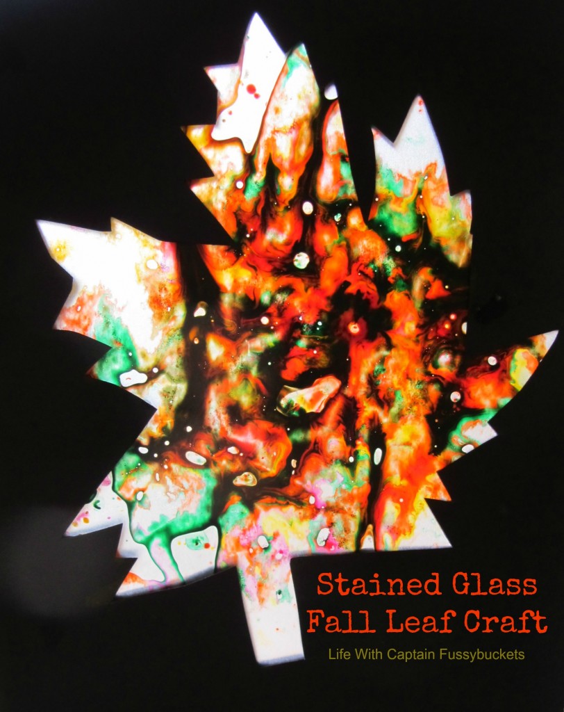 Fall stained glass leaf craft for kids from Ginger Casa shown on black with colorful leaf shape