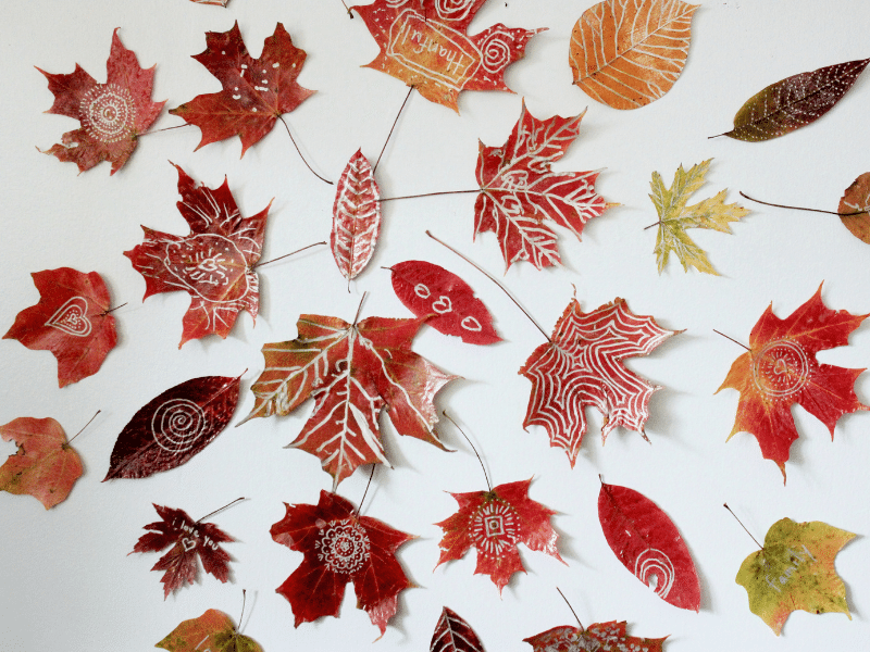 leaf mandala crafts for kids shown with gold and silver metallic leaf art from Artful Parent