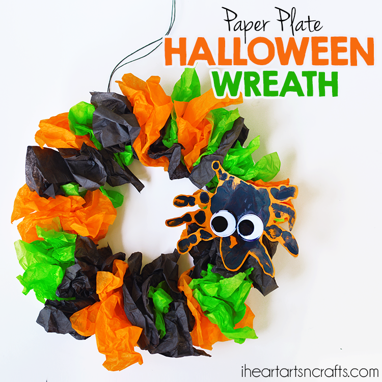 tissue paper wreath for Halloween with a handprint spider decor with big eyes