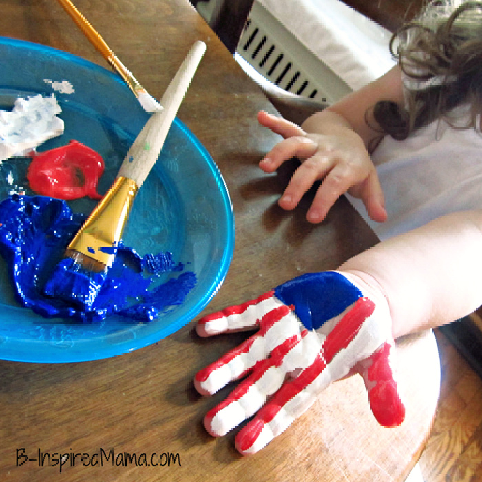 little girls hand painted with red white and blue like american flag