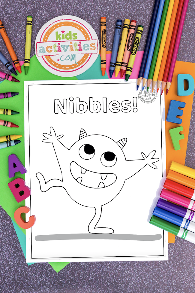 Nibbles the book monster coloring page surrounded by coloring art supples and ABC\'s