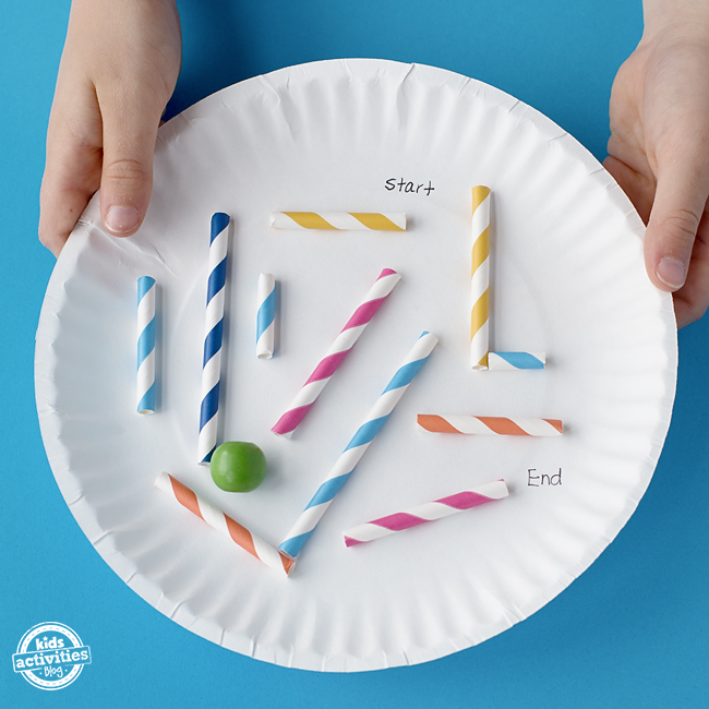 A marble moves through the maze of straws on the paper plate, from start to end.